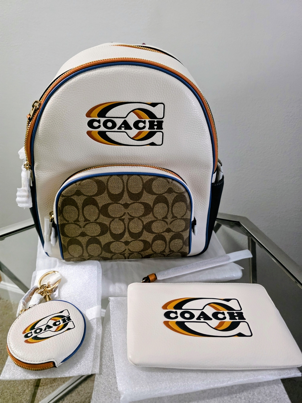 Coach White Leather Backpack with Brown Signature Pocket and Orange/Blue Accents